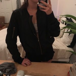 Black bomber jacket with zipper details.